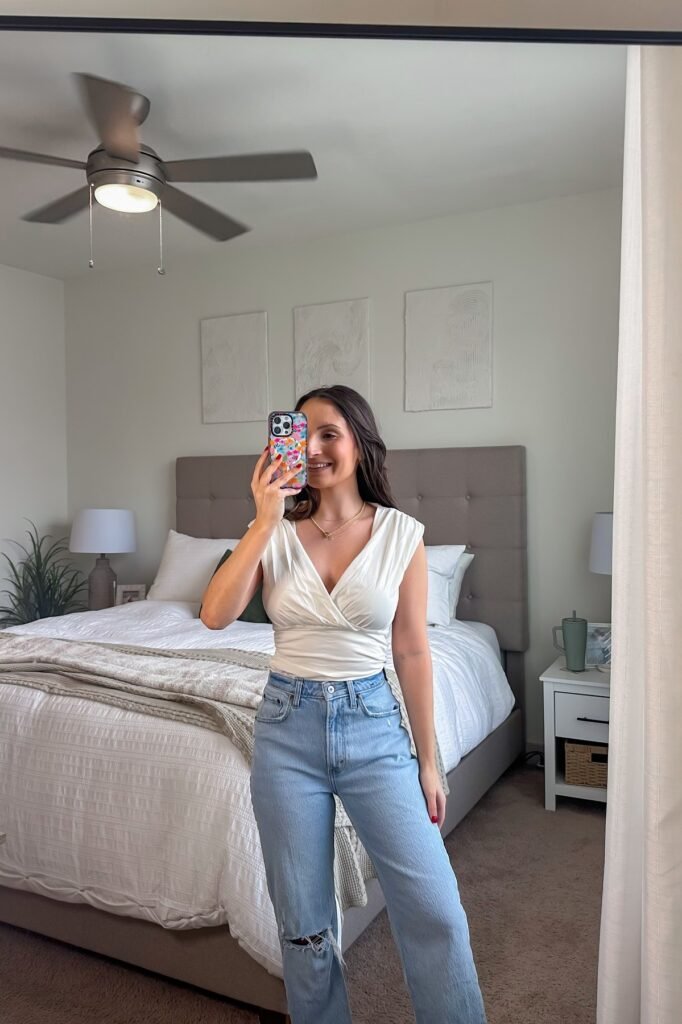 White V Neck Sleeveless Ruched Top + Light Wash Distressed Straight Leg Jeans