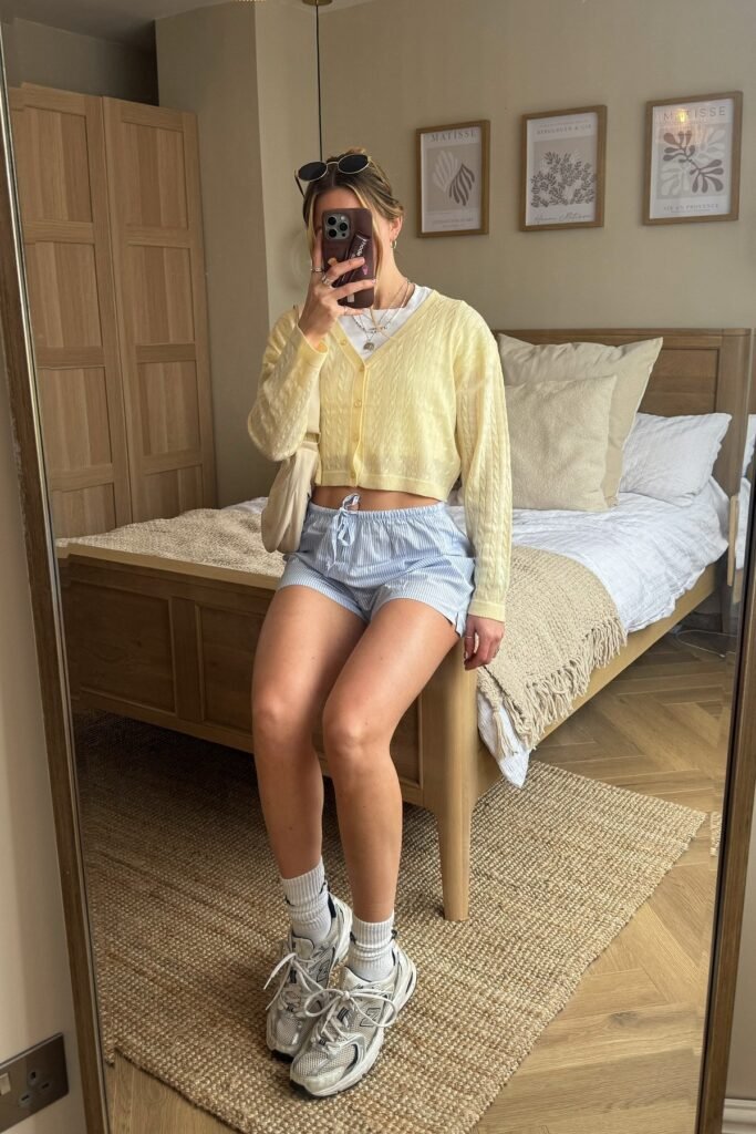 Yellow Cable-Knit Cardigan + Blue Striped Shorts + White Sneakers