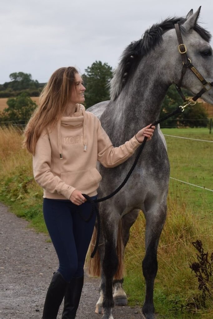 Beige Cowl-Neck Hoodie + Navy Equestrian Leggings + Black Tall Riding Boots