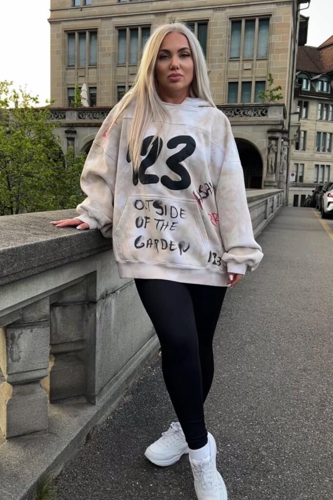 Beige Graphic Hoodie + Black Leggings + White Sneakers