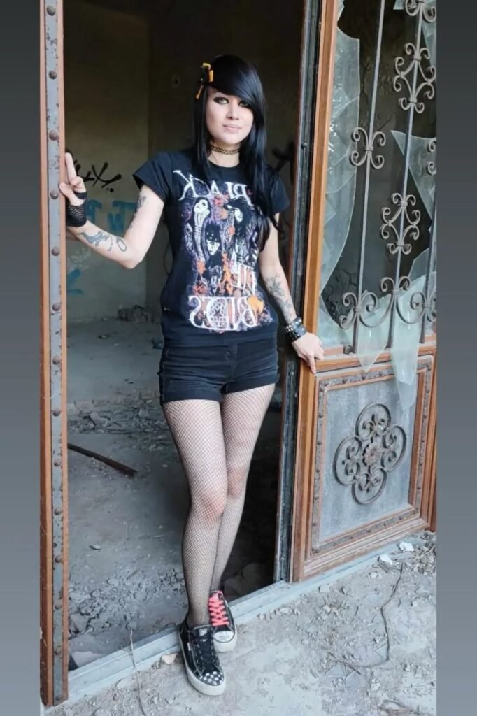 Black Band T-Shirt + Black Mini Shorts + Fishnet Tights + Mismatched Laced Sneakers