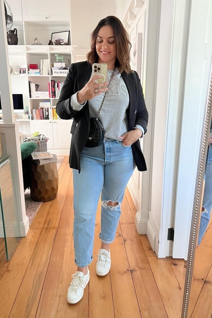 Black Blazer + Grey Graphic Sweatshirt + Light Wash Distressed Jeans + White Studded Sneakers