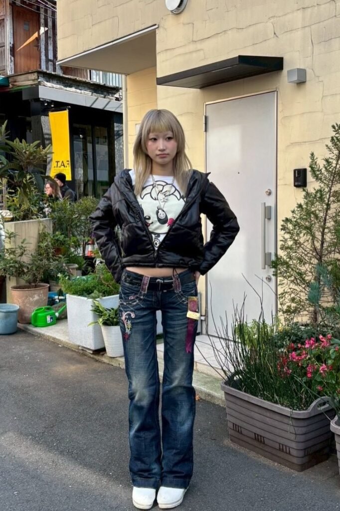 Black Cropped Puffer Jacket + White Graphic T-Shirt + Low-Rise Embroidered Flare Jeans + White Platform Shoes