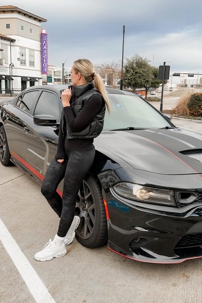 Black Cropped Puffer Vest + Black Long-Sleeve Top + Camo Leggings + Chunky White Sneakers