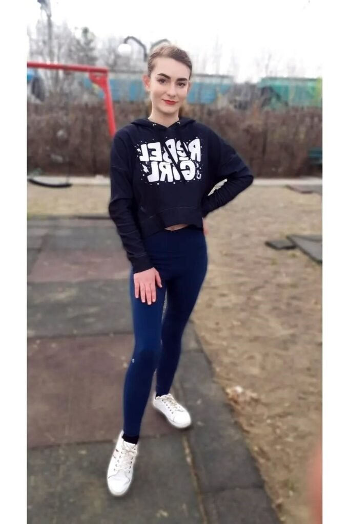 Black Cropped "Rebel Girl" Hoodie + Navy Blue Leggings + White Low-Top Sneakers