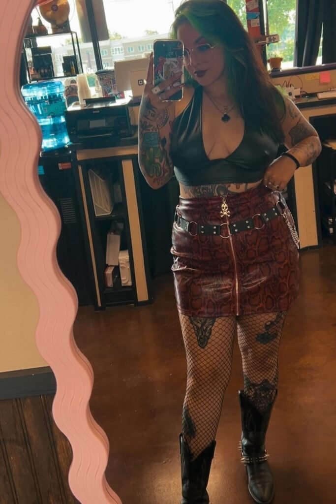 Black Faux-Leather Halter Top + Red Snakeskin Mini Skirt + Fishnet Tights + Black Cowboy Boots