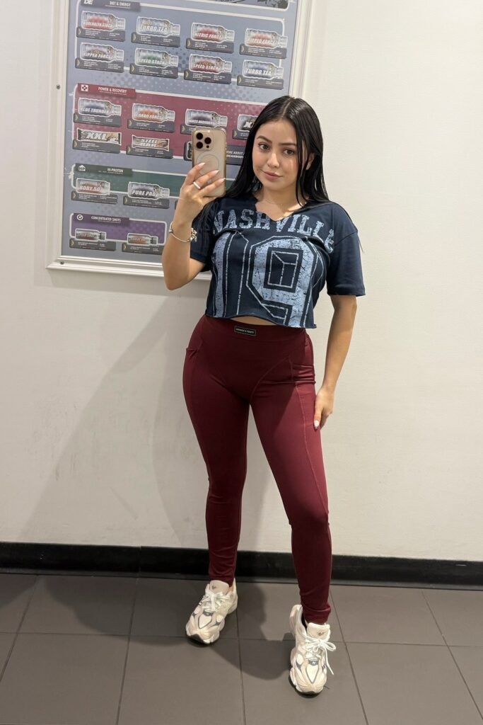 Black Graphic Crop Top + Burgundy High-Waisted Leggings + Chunky White Sneakers