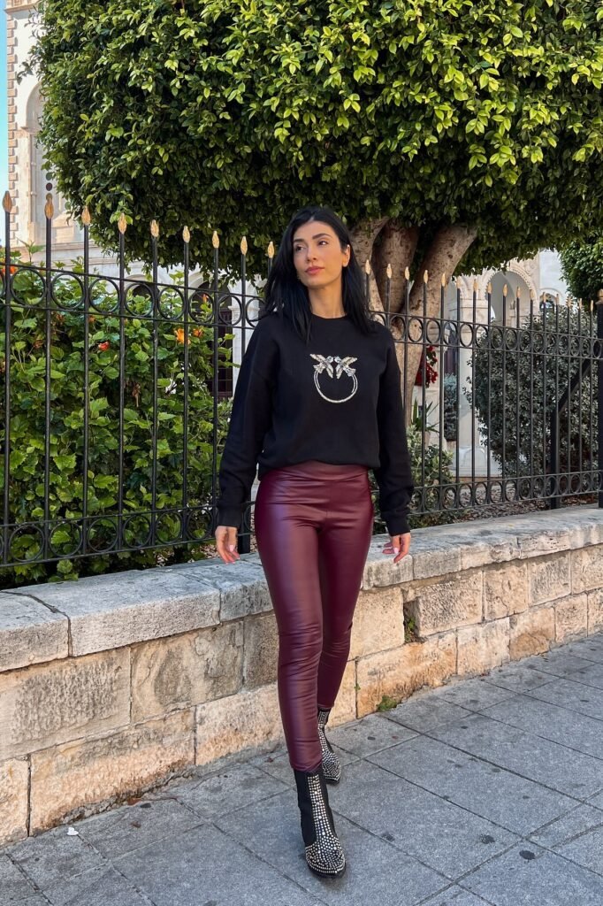 Black Graphic Sweatshirt + Burgundy Faux Leather Leggings + Studded Black Boots