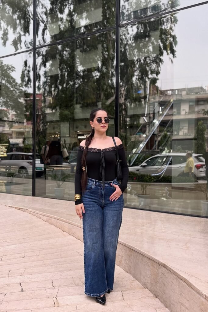 Black Lace-Trimmed Off-the-Shoulder Bodysuit + Dark Wash Wide Leg Jeans + Black Pointed Heels