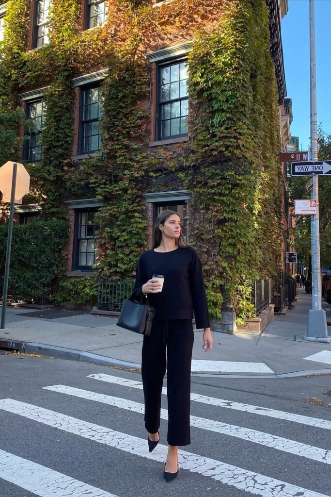 Black Long-Sleeve Ribbed Top + Matching Straight-Leg Trousers + Black Pointed-Toe Pumps + Black Leather Tote
