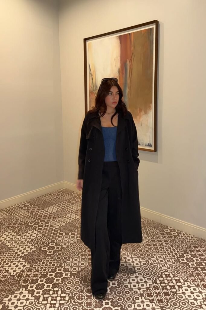 Black Long Trench Coat + Blue Corset Top + Black Wide-Leg Trousers + Black Boots