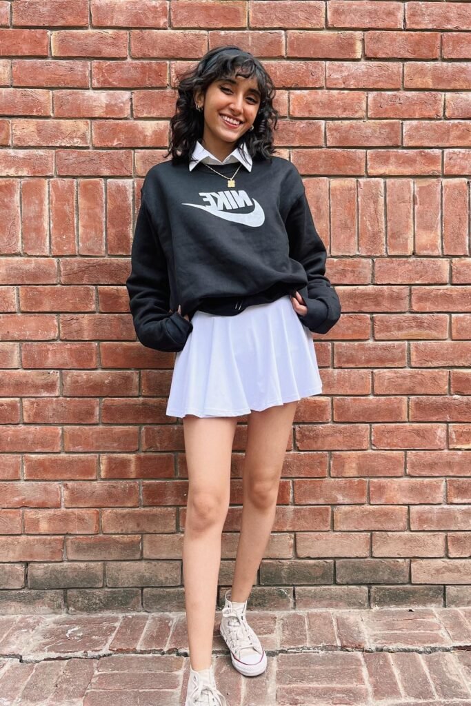 Black Nike Sweatshirt + White Collared Shirt + White Pleated Mini Skirt + White High-Top Sneakers