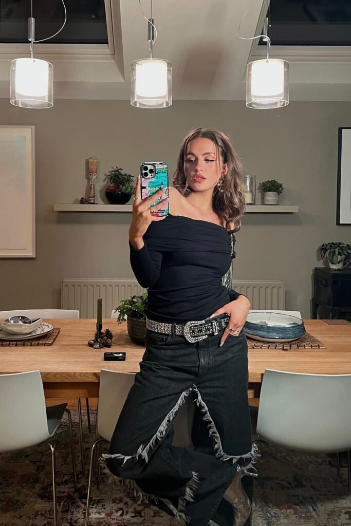 Black Off-the-Shoulder Ruched Long-Sleeve Top + Black Distressed Frayed Jeans + Silver Pointed-Toe Boots