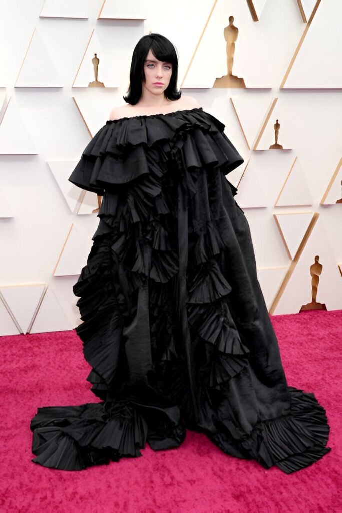 Black Off-the-Shoulder Ruffled Gown + Black Statement Wig + Pink Lipstick