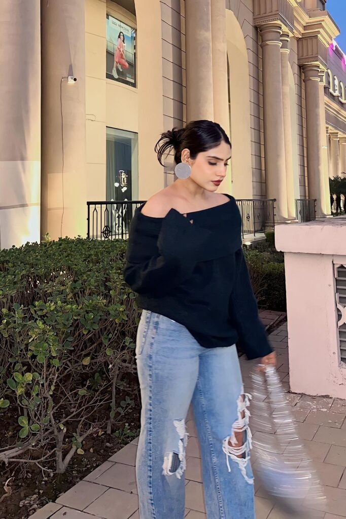 Black Off-the-Shoulder Sweater + Distressed Light Wash Jeans + Large Silver Disc Earrings