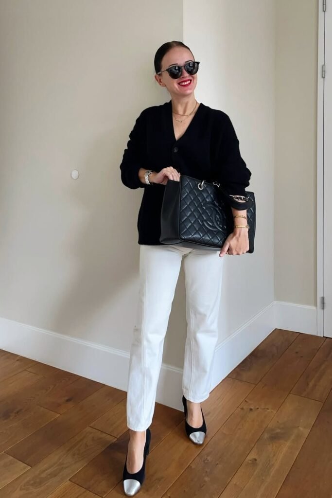 Black Oversized Cardigan + White Straight-Leg Jeans + Black and Silver Cap-Toe Pumps