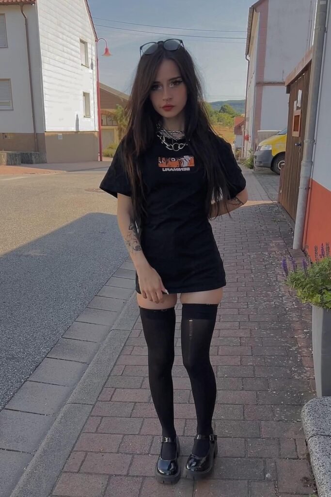 Black Oversized Graphic T-Shirt + Black Thigh-High Stockings + Silver Layered Chains + Black Chunky Mary Janes