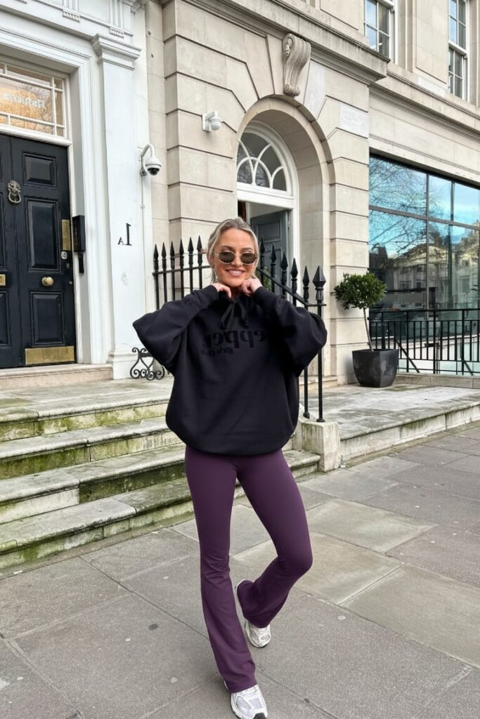 Black Oversized Hoodie + Dark Purple Flared Leggings + Grey Athletic Sneakers