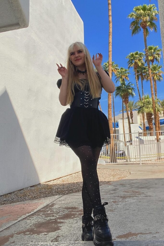 Black Puff-Sleeve Mini Dress + Heart-Buckle Corset Belt + Sparkly Tights + Black Platform Sneakers