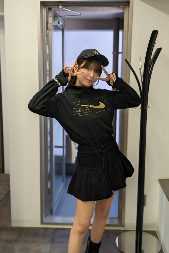 Black Quarter-Zip Pullover + Black Lace-Up Mini Skirt + Black Baseball Cap + Black Ankle Boots