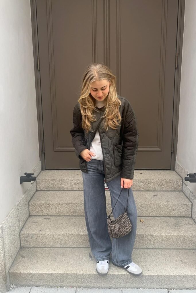 Black Quilted Liner Jacket + White Knit Sweater + Grey Wide-Leg Jeans + White and Grey Sneakers