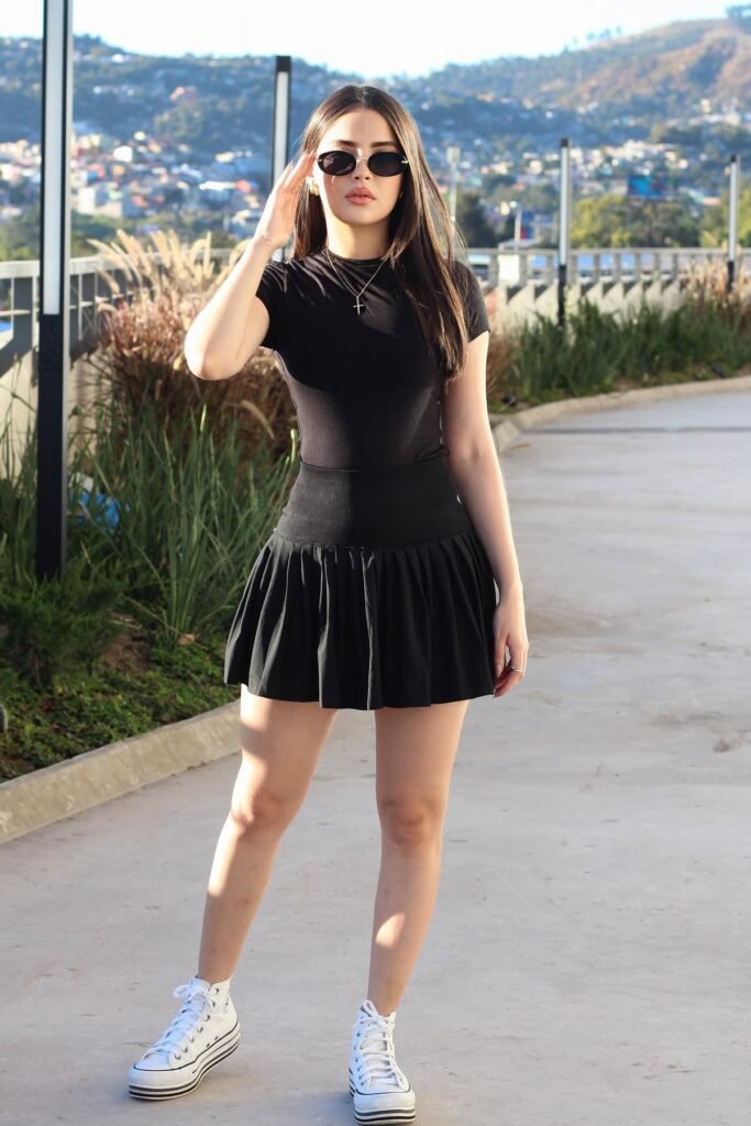 Black Short Sleeve Bodysuit + Black Pleated Skater Skort + White High-Top Sneakers