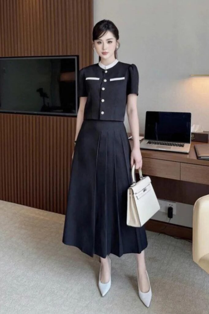 Black Short-Sleeve Button-Up Jacket + Black Pleated Midi Skirt + White Pointed-Toe Pumps