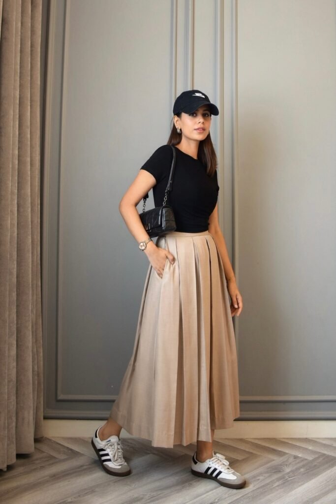 Black Short-Sleeve T-Shirt + Tan Pleated Maxi Skirt + Black and White Adidas Samba Sneakers