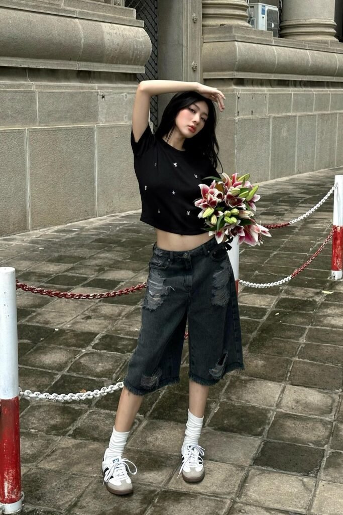 Black Shrunken Graphic Tee + Distressed Black Denim Jorts + White Crew Socks + Black and White Sneakers