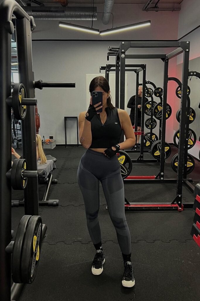 Black Sleeveless Zip-Up Crop Top + Dark Grey Paneled Performance Leggings + Black and White Sneakers