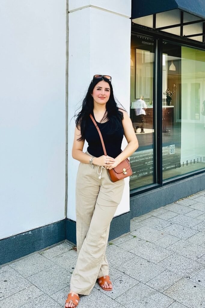 Black Tank Top + Beige Linen Trousers + Tan Leather Sandals