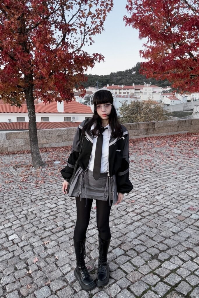 Black Techwear Jacket + White Shirt and Black Tie + Grey Pleated Skirt + Black Platform Boots