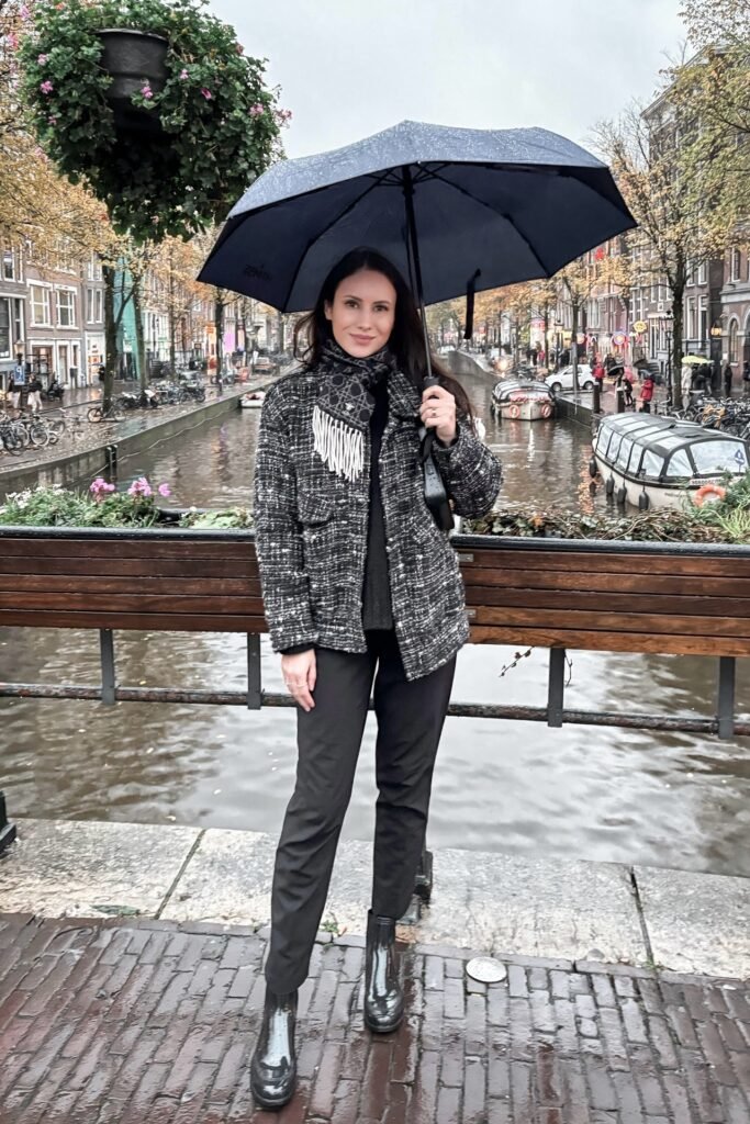 Black Turtleneck + Black and White Tweed Jacket + Black Tailored Trousers + Glossy Black Ankle Boots