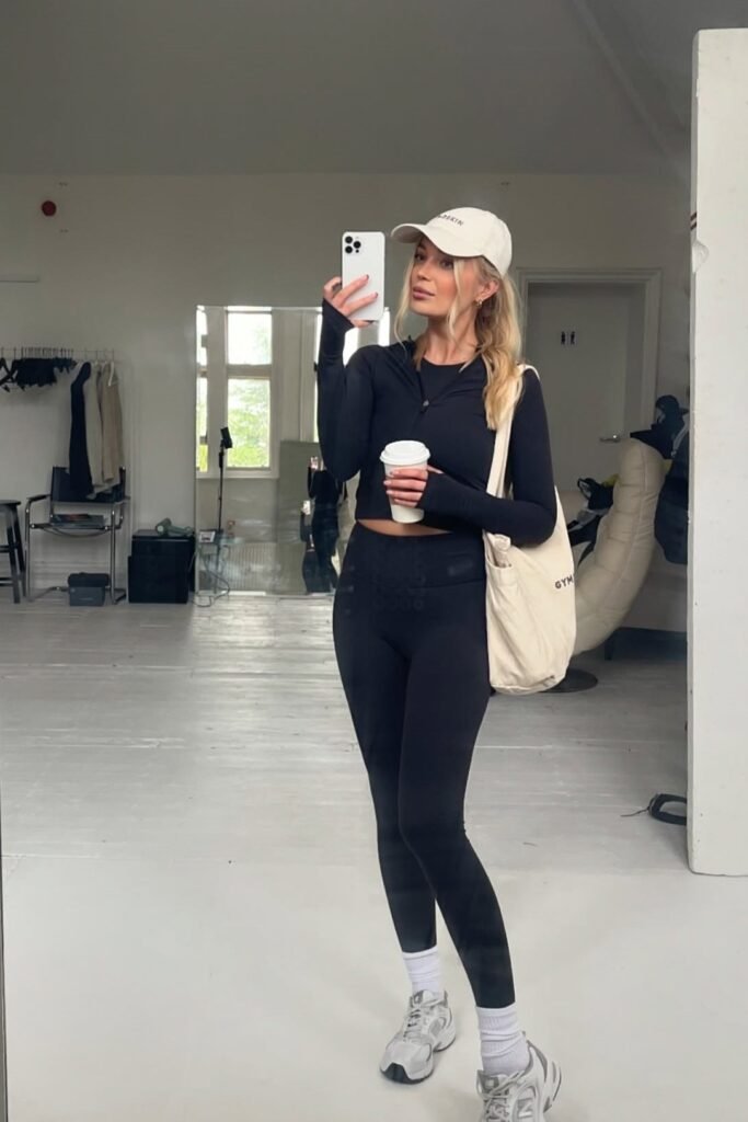 Black Zip-up Crop Top + Black Leggings + Grey Sneakers + White Baseball Cap