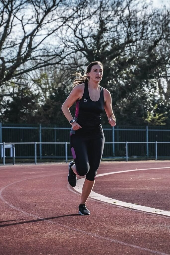 Black and Magenta Athletic Tank Top + Matching Black Cropped Performance Leggings + Black Running Shoes