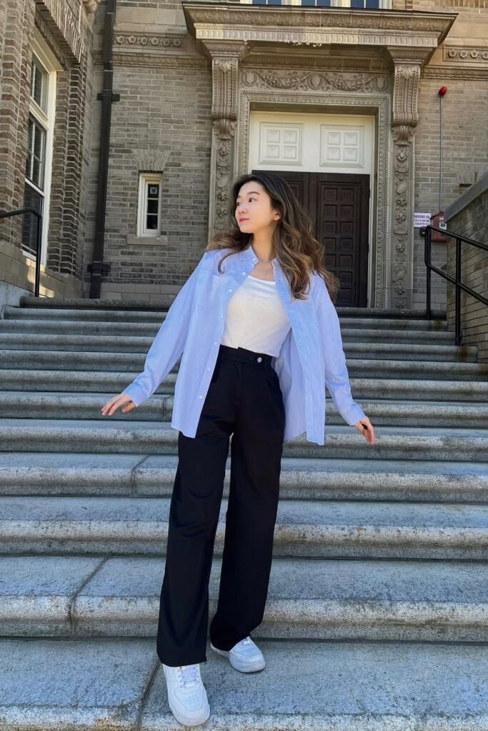 Blue Striped Button-Down Shirt over White Tank Top + Black Wide-Leg Trousers + White Sneakers