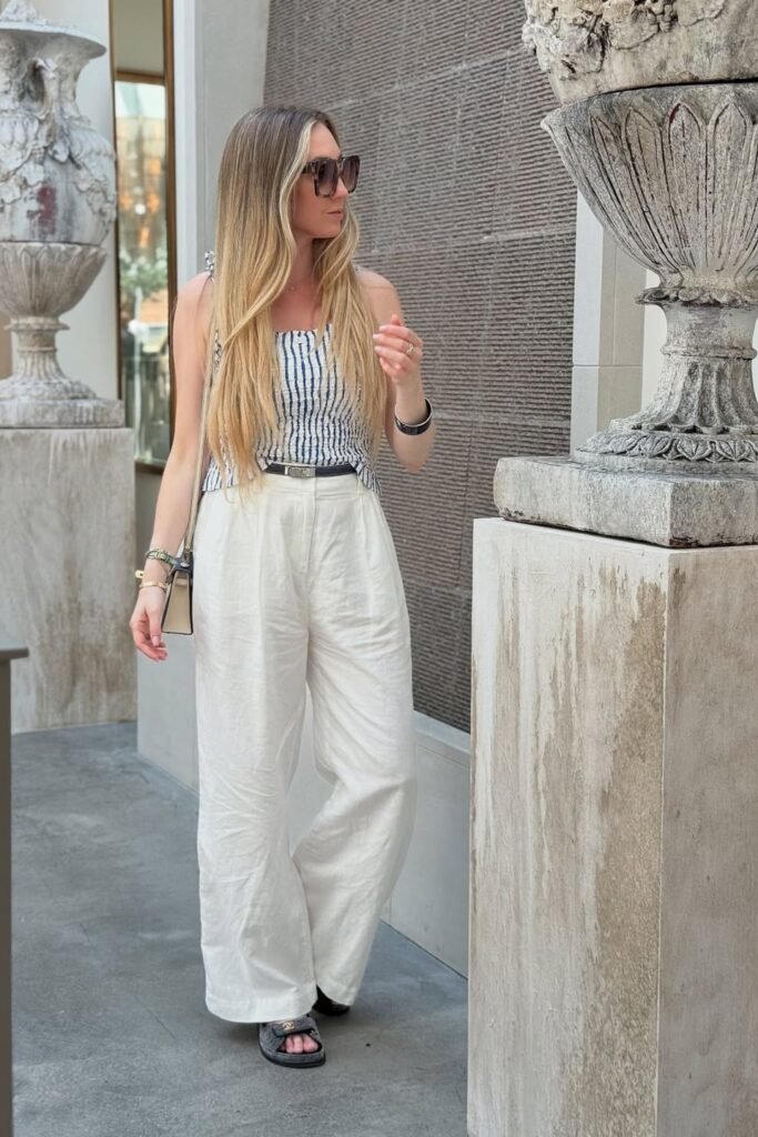 Blue and White Striped Smocked Top + White Linen Wide-Leg Pants + Grey Slides
