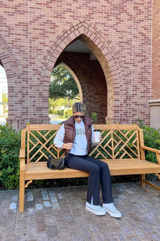 Brown Puffer Vest + Grey Graphic Sweatshirt + Black Flared Leggings + White Platform Sneakers