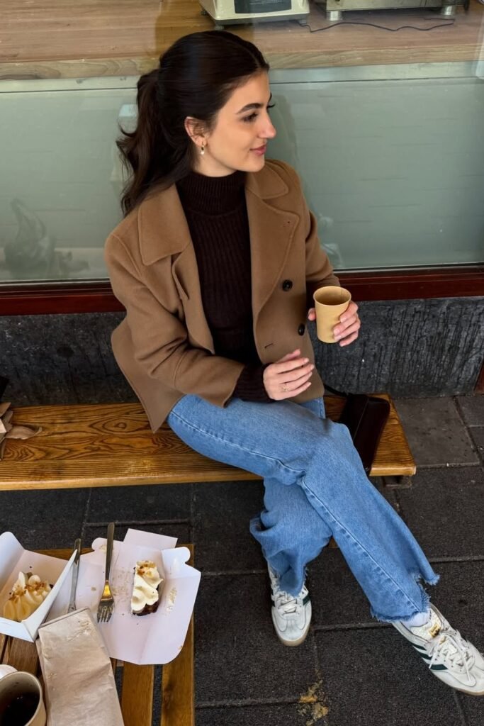 Camel Wool Coat + Dark Brown Turtleneck + Light Blue Wide-Leg Jeans + White & Green Sneakers