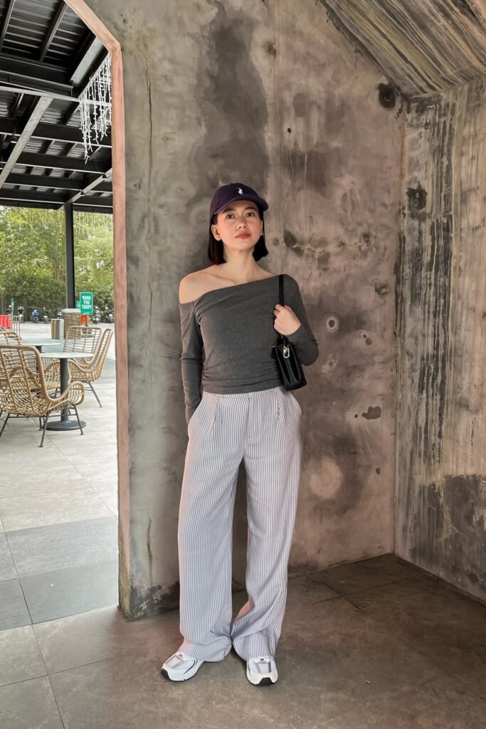 Charcoal Off-the-Shoulder Long Sleeve Top + Grey Pinstriped Wide-Leg Trousers + White Athletic Sneakers