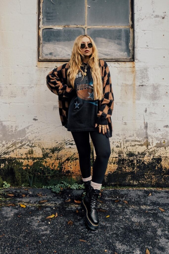 Checkered Brown Cardigan + Graphic T-Shirt + Black Leggings + Black Combat Boots
