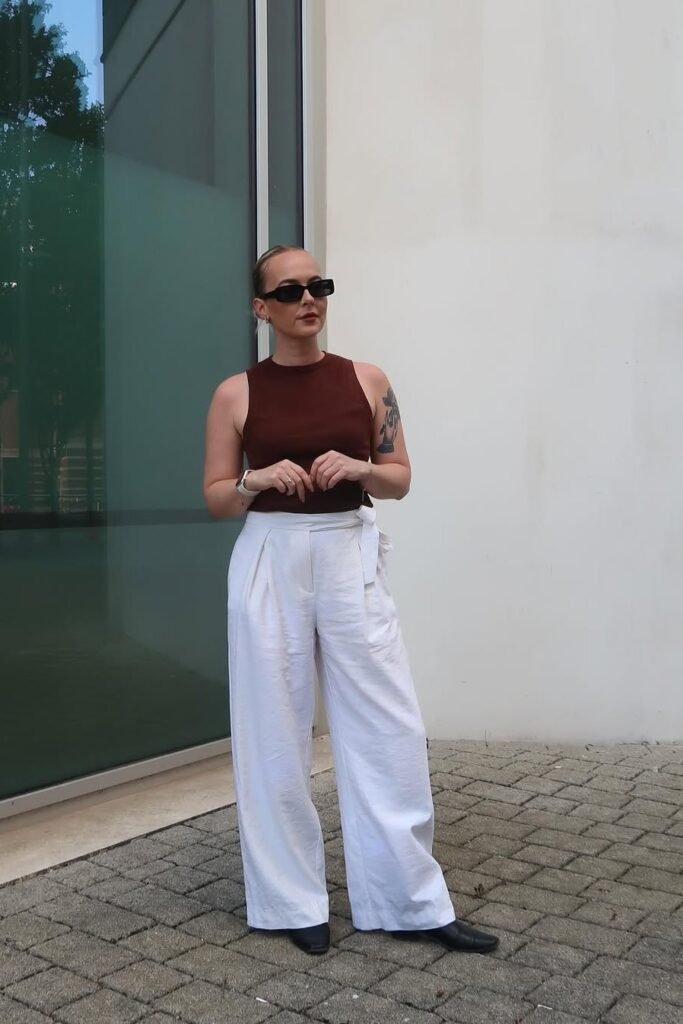 Chocolate Brown Sleeveless Bodysuit + White Wide-Leg Linen Trousers + Black Square-Toe Boots