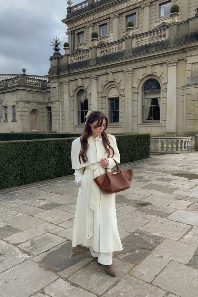 Cream Belted Cape Coat + White Wide-Leg Trousers + Brown Suede Pointed-Toe Boots