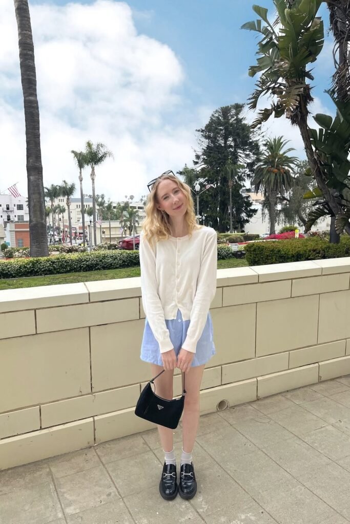 Cream Button-Up Cardigan + Light Blue Shorts + Black Loafers with White Socks