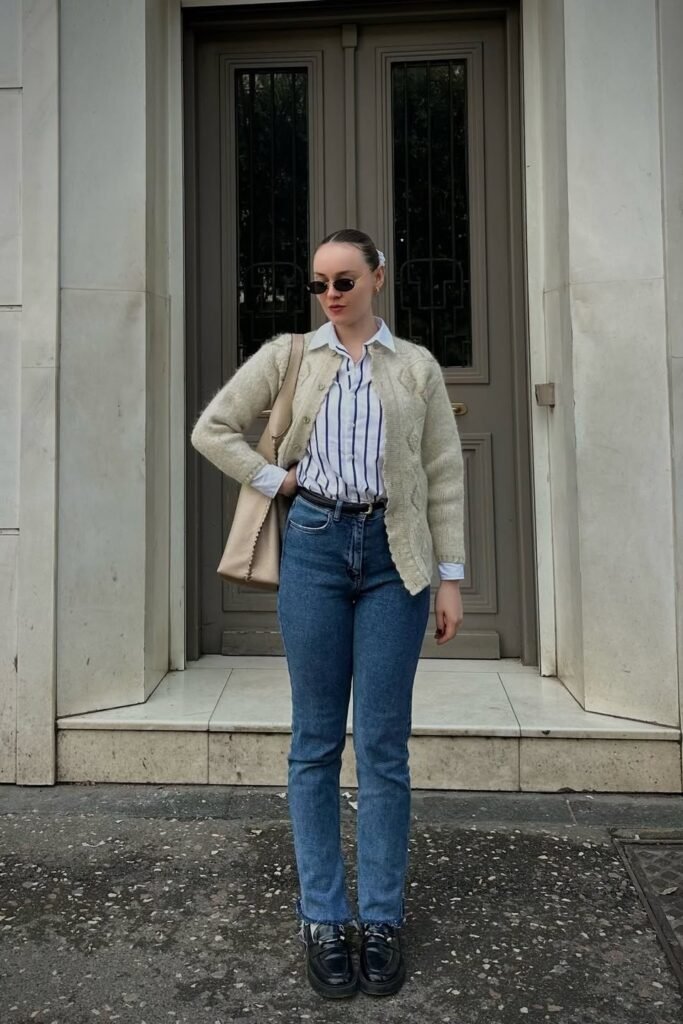 Cream Cable-Knit Cardigan + Blue Striped Button-Down + Medium Wash Straight-Leg Jeans + Black Loafers