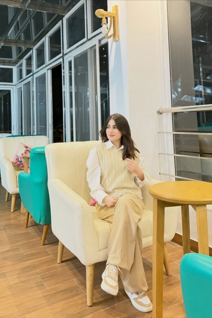 Cream Cable-Knit Sweater Vest + White Collared Shirt + Beige Wide-Leg Trousers + Tan and White Sneakers