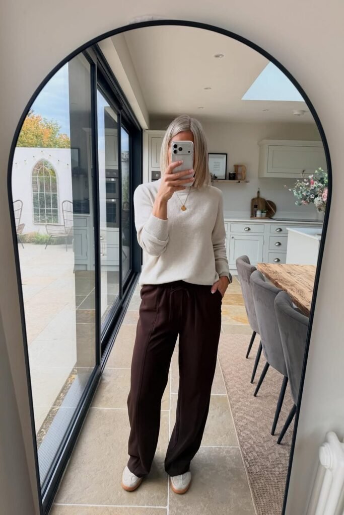 Cream Crewneck Sweater + Dark Brown Relaxed Trousers + White Sneakers