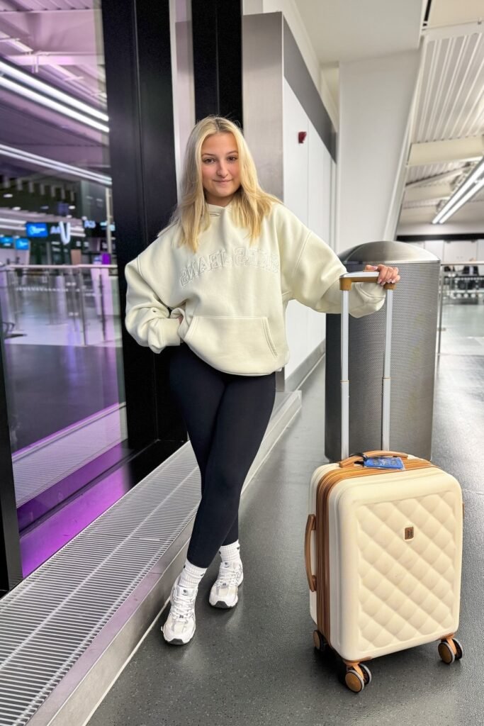Cream Graphic Hoodie + Black Leggings + White Chunky Sneakers