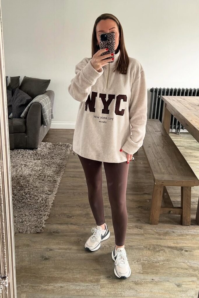Cream "NYC" Quarter-Zip Sweatshirt + Brown Leggings + White and Black Sneakers