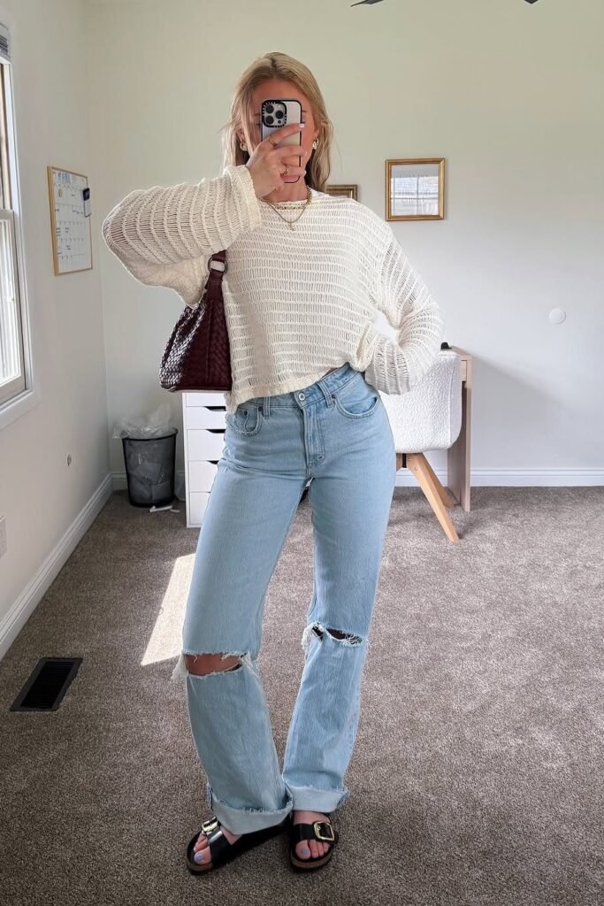 Cream Open-Knit Sweater + Distressed Light Wash Straight-Leg Jeans + Black Buckled Slides